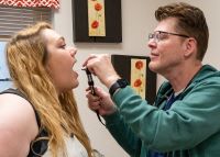 Doctor looking in patient mouth